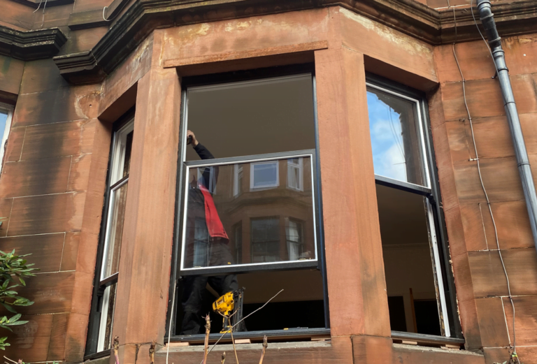 Repair of a sash and cash window in a red sandstone tenement building
