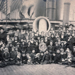 Children posed on the deck of a ship