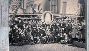 Children posed on the deck of a ship