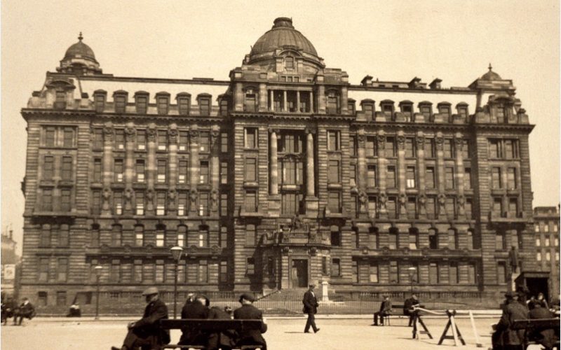 The James Miller building shortly after it was built with edwardian people sitting in cathedral square