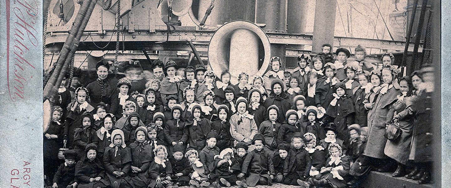 Children posed on the deck of a ship